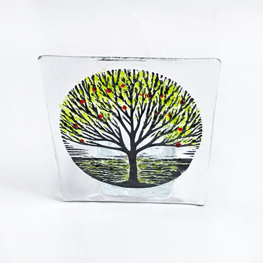 Handmade fused glass tealight holder featuring a green tree design with red accents. A beautiful nature-inspired glass gift for the home.